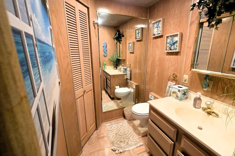 Slide: The Image of Bathroom in 1996 Sumerset 82'x18' Widebody houseboat with wood paneling and nautical decor. - 22