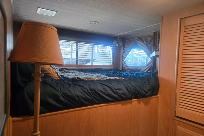 Slide: The Image of Cozy bedroom in 1996 Sumerset 82'x18' Widebody houseboat with bed, lamp, and window blinds. - 25