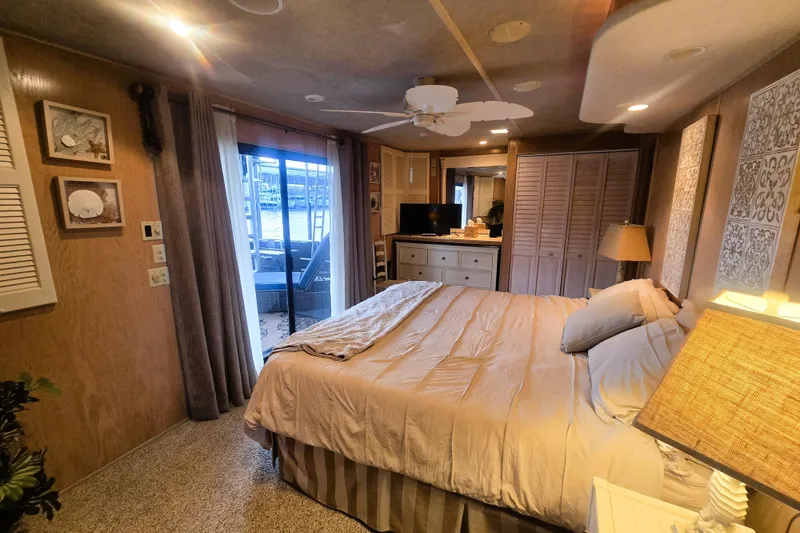 Slide: The Image of Cozy bedroom in a 1996 Sumerset 82'x18' Widebody houseboat with elegant decor. - 28