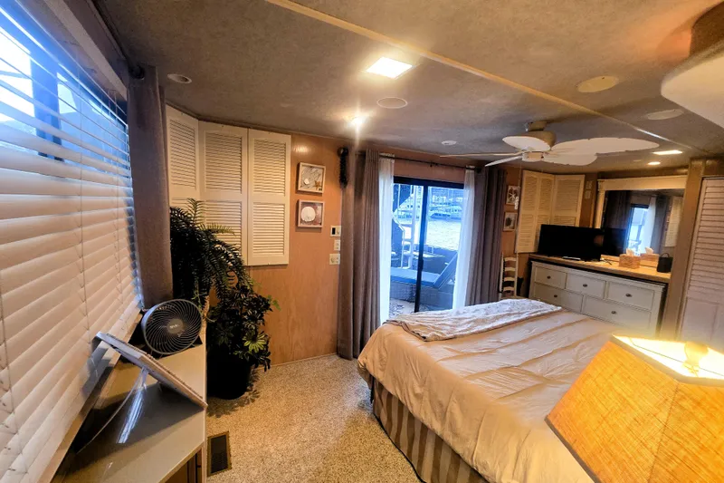 Slide: The Image of Cozy bedroom interior of a 1996 Sumerset 82'x18' Widebody houseboat with lake view. - 29