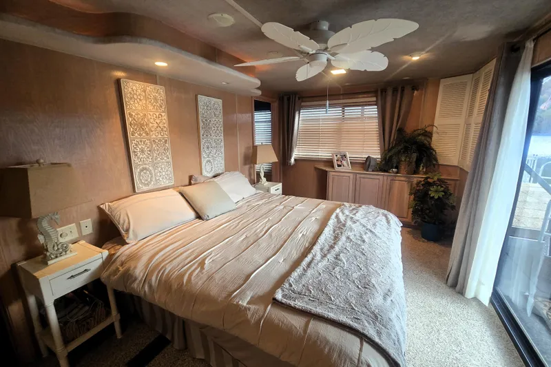 Slide: The Image of Cozy bedroom in a 1996 Sumerset 82'x18' Widebody houseboat with elegant decor and natural light. - 31