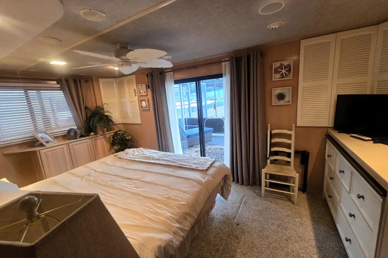Slide: The Image of Cozy bedroom in a 1996 Sumerset 82'x18' Widebody houseboat with elegant decor and natural light. - 32