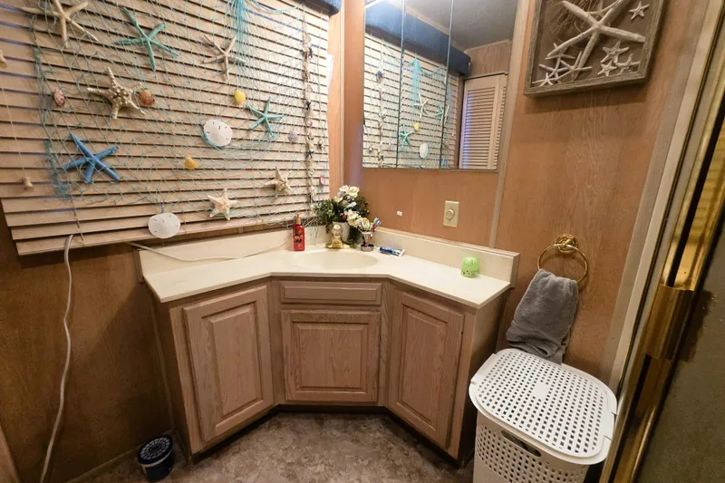 Slide: The Image of Bathroom in 1996 Sumerset Widebody houseboat with nautical decor and wooden cabinetry. - 34