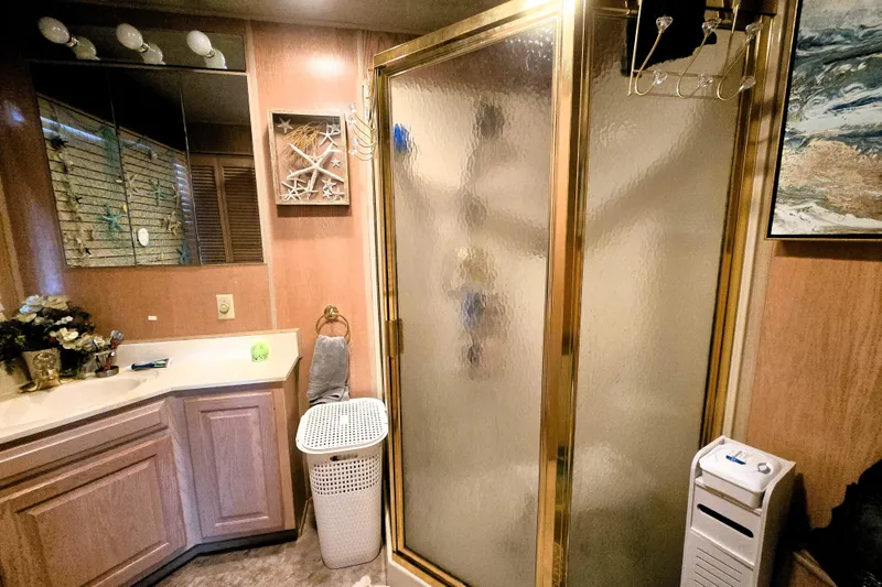 Slide: The Image of Bathroom interior of 1996 Sumerset 82'x18' Widebody with shower, vanity, and decor. - 35