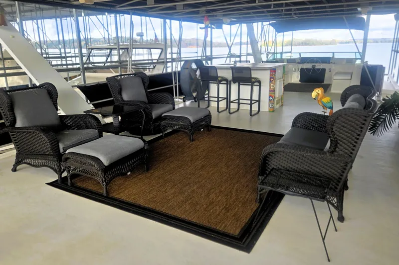 Slide: The Image of Luxurious 1996 Sumerset 82'x18' Widebody houseboat interior with wicker furniture and bar area. - 41