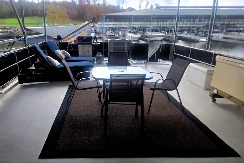 Slide: The Image of Luxurious 1996 Sumerset 82'x18' Widebody houseboat deck with seating and scenic marina view. - 42