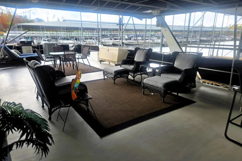 Slide: The Image of Spacious deck of 1996 Sumerset 82'x18' Widebody houseboat with wicker furniture and marina view. - 45