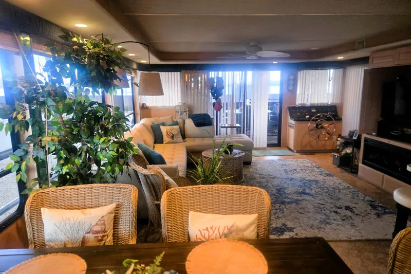 Slide: The Image of Interior of a 1996 Sumerset 82'x18' Widebody houseboat, featuring cozy seating and decor. - 8