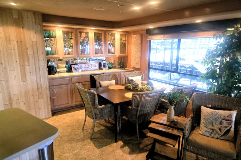 Slide: The Image of Luxurious 1996 Sumerset 82'x18' Widebody houseboat interior with elegant dining area and large windows. - 9