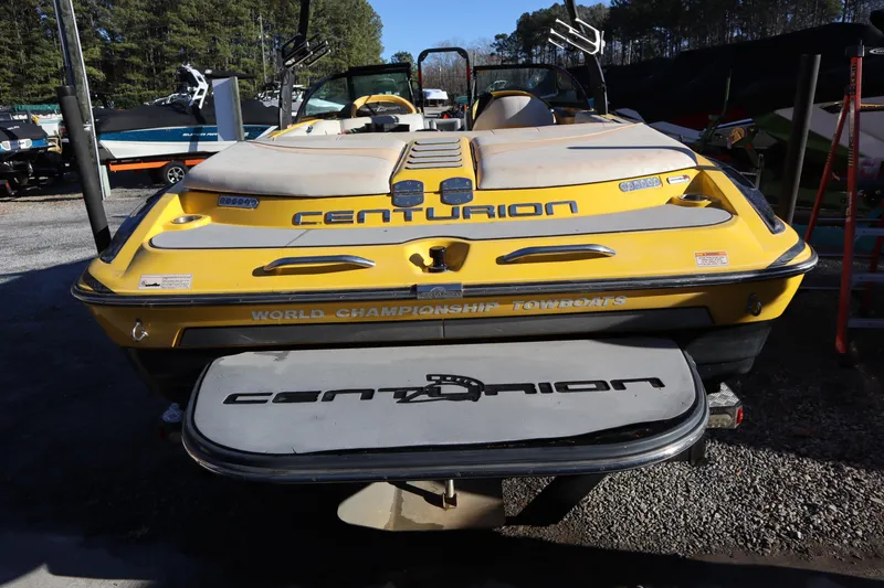 Slide: The Image of 2014 Centurion Enzo SS210 yellow boat, rear view, parked outdoors. - 3