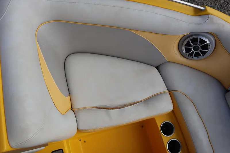 Slide: The Image of 2014 Centurion Enzo SS210 boat interior with yellow and gray seating, speaker, and cup holders. - 5