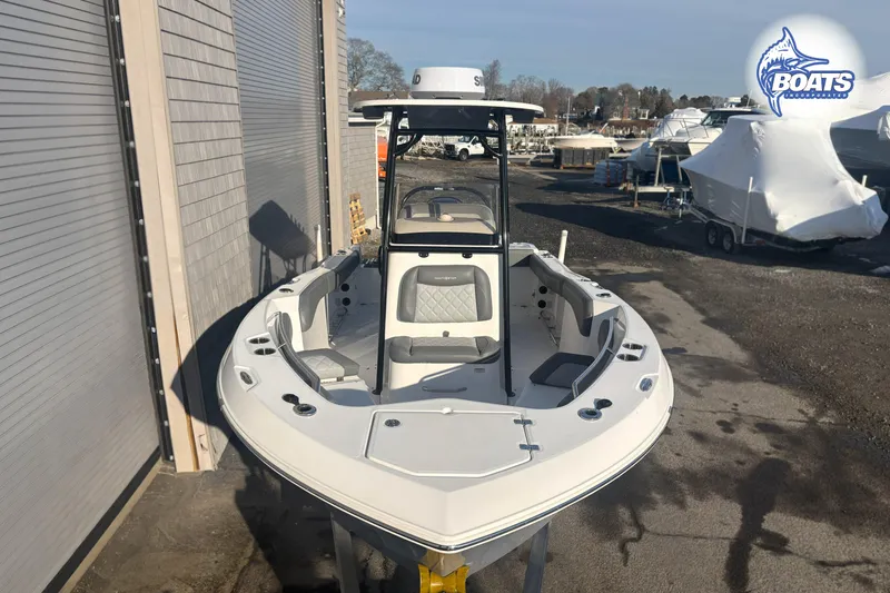 Slide: The Image of 2024 NauticStar 222 Offshore boat docked, featuring spacious seating and modern design. - 2