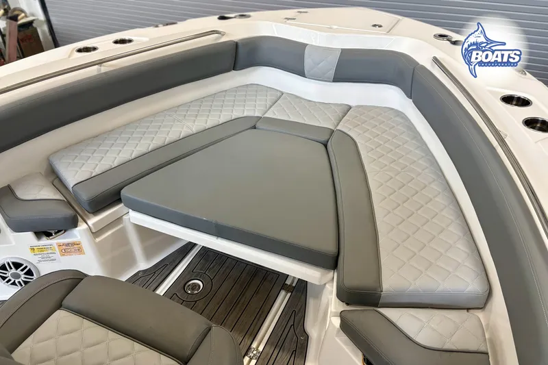 Slide: The Image of 2024 NauticStar 222 Offshore boat interior with cushioned seating and cup holders. - 3