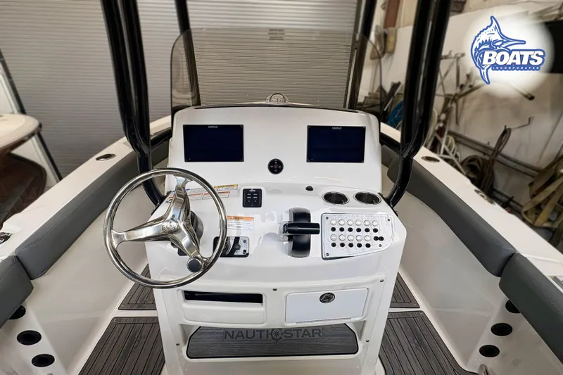 Slide: The Image of 2024 NauticStar 222 Offshore boat console with steering wheel and controls. - 8