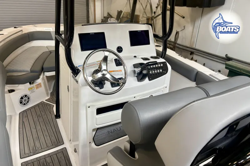 Slide: The Image of 2024 NauticStar 222 Offshore boat interior with steering console and seating. - 9