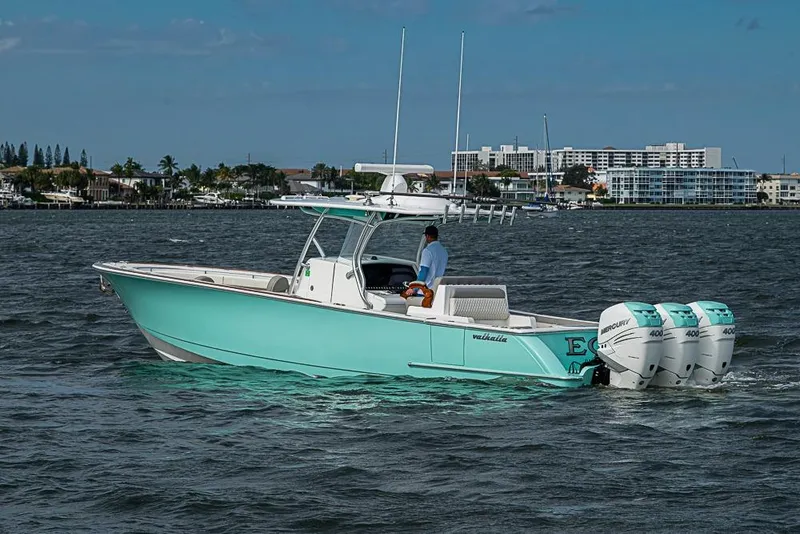 Slide: The Image of 2020 Valhalla Boatworks V-37 cruising on a sunny day near coastal buildings. - 11