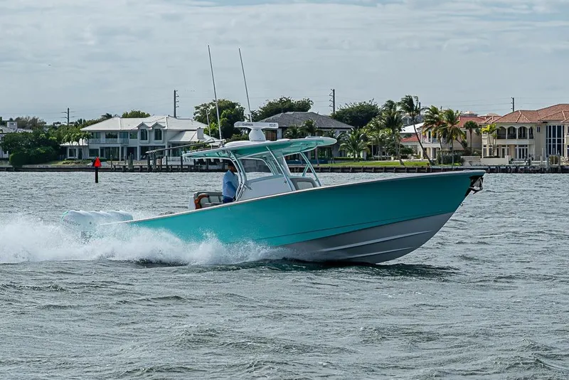 Slide: The Image of 2020 Valhalla Boatworks V-37 cruising on water near waterfront homes. - 2