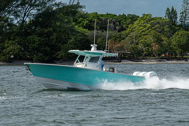 Slide: The Image of 2020 Valhalla Boatworks V-37 cruising on water near lush shoreline. - 6