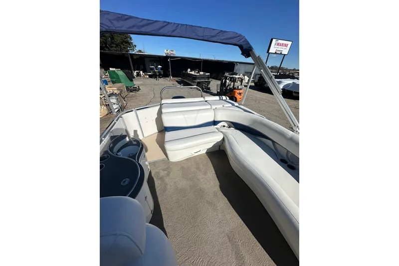 Slide: The Image of 2007 Harris Royal Heritage 260 O/B boat interior with white seating and blue canopy. - 11