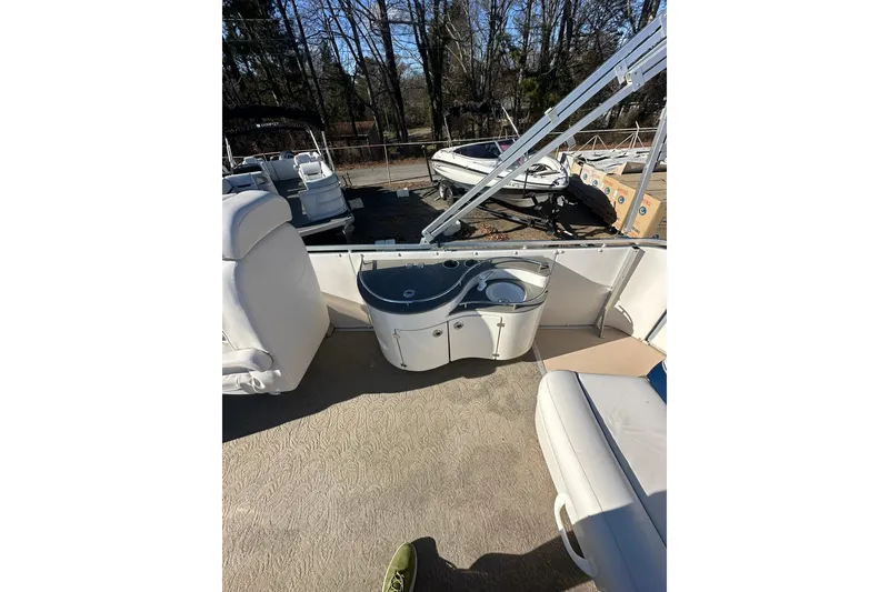 Slide: The Image of 2007 Harris Royal Heritage 260 O/B boat interior with seating and storage. - 12