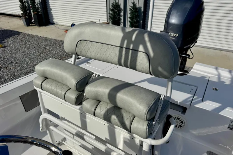 Slide: The Image of 2020 Sportsman Masters 207 Bay Boat with cushioned seating and outboard motor. - 10