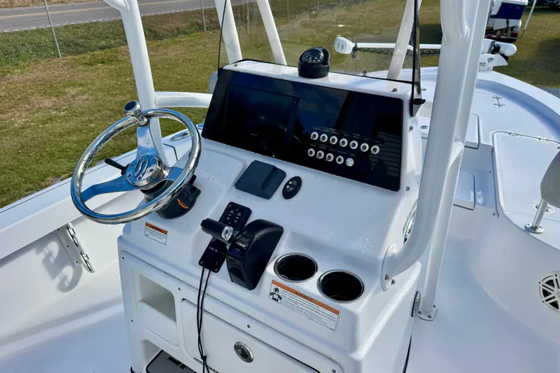 Slide: The Image of 2020 Sportsman Masters 207 Bay Boat console with steering wheel and controls. - 14