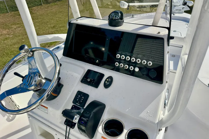 Slide: The Image of 2020 Sportsman Masters 207 Bay Boat dashboard with steering wheel and control panel. - 16
