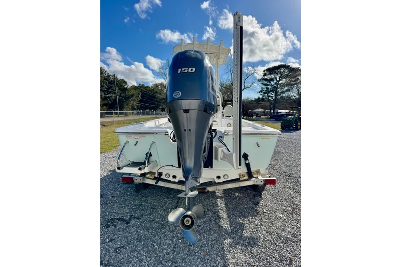 Slide: The Image of 2020 Sportsman Masters 207 Bay Boat with 150 HP engine on gravel lot. - 5