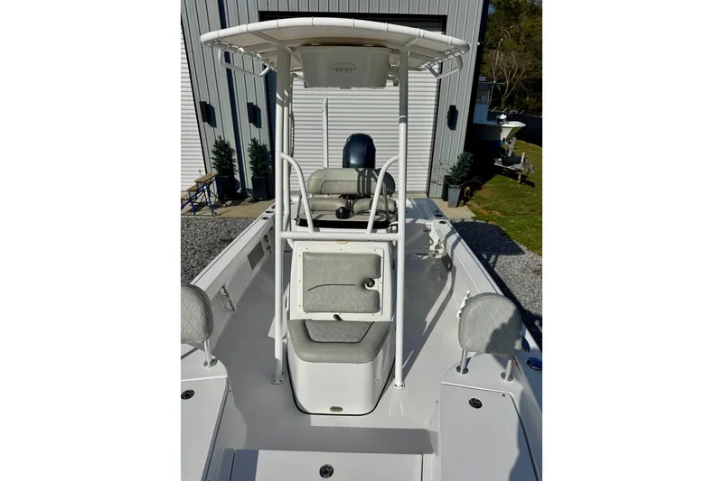 Slide: The Image of 2020 Sportsman Masters 207 Bay Boat with T-top and seating, parked outdoors. - 8