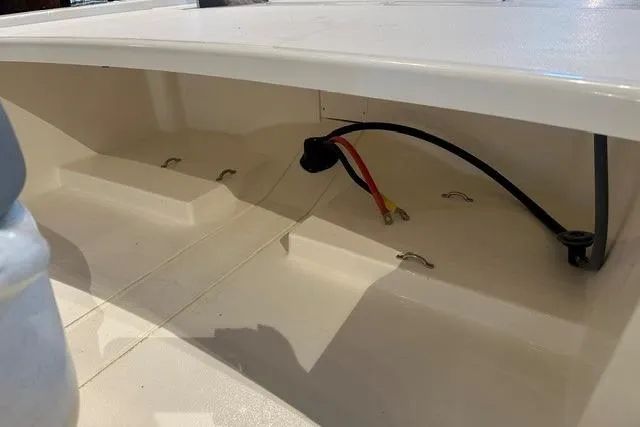 Slide: The Image of 2026 Mako Pro Skiff 13 CC interior wiring and storage compartment. - 10