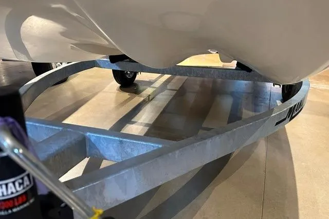 Slide: The Image of 2026 Mako Pro Skiff 13 CC boat on a trailer, showcasing hull design. - 13