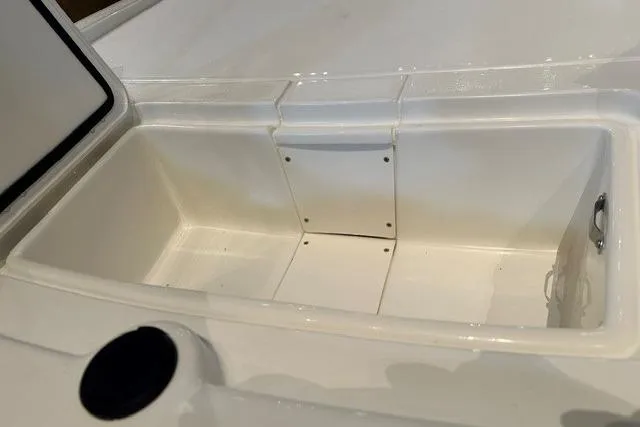 Slide: The Image of 2026 Mako Pro Skiff 13 CC storage compartment, open and empty, showcasing interior space. - 11