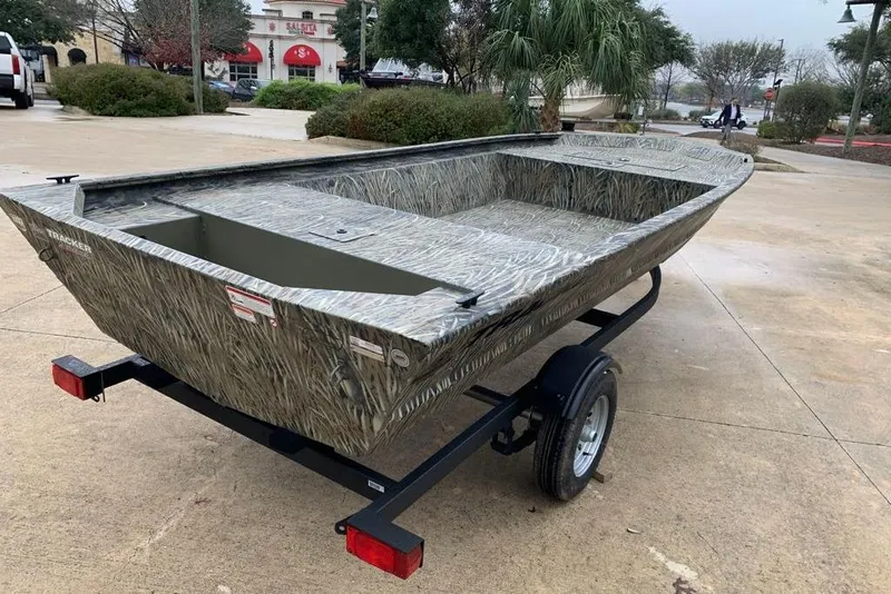 Slide: The Image of 2026 Tracker Grizzly 1648 Utility boat on trailer, parked outdoors. - 5