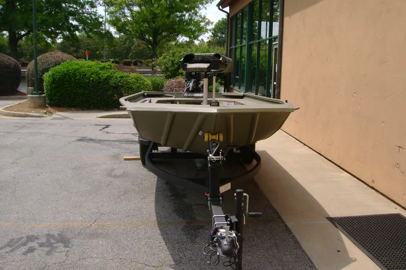 Slide: The Image of 2026 Tracker Grizzly 1654 T Sportsman boat parked outdoors on a trailer. - 3