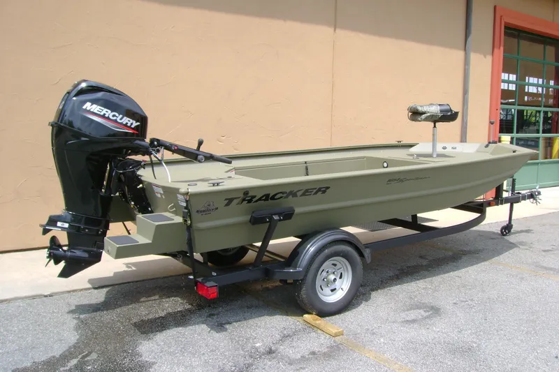 Slide: The Image of 2026 Tracker Grizzly 1654 T Sportsman boat with Mercury engine on trailer. - 2