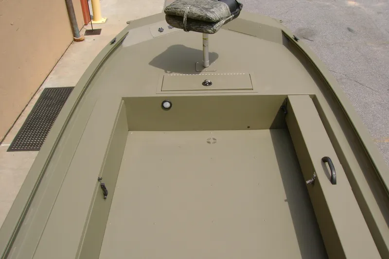 Slide: The Image of 2026 Tracker Grizzly 1654 T Sportsman boat interior with seating and storage compartments. - 6