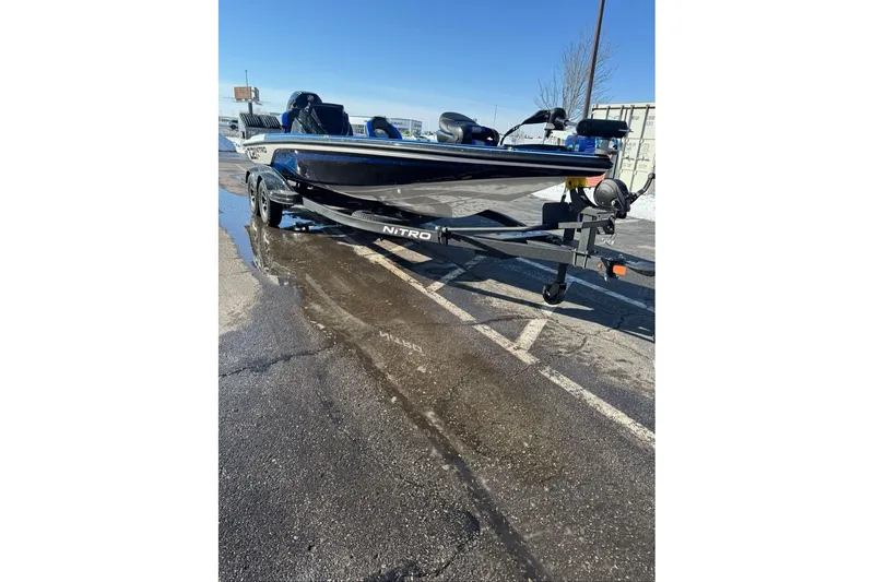 Slide: The Image of 2026 Nitro Z21 XL boat on trailer in parking lot, clear sky background. - 120