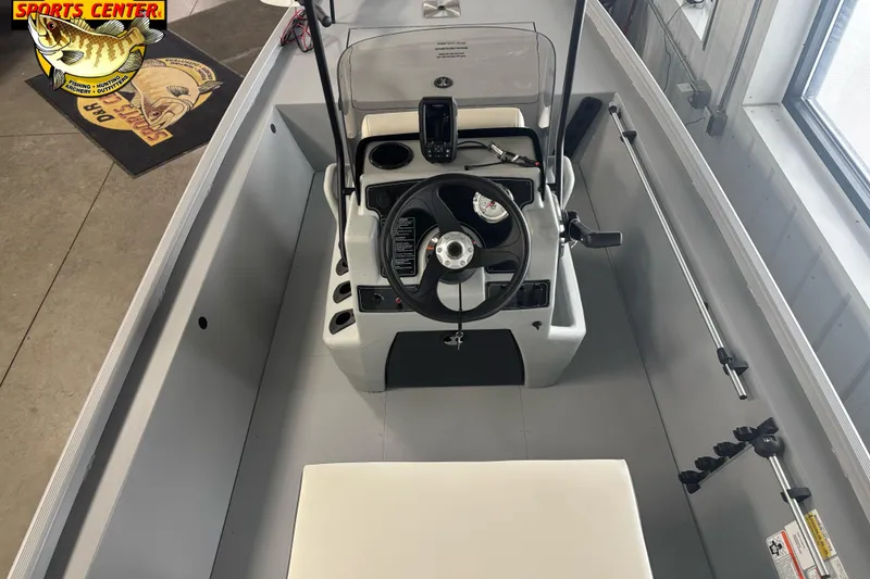 Slide: The Image of 2026 Tracker Bass Tracker Classic CC boat interior with steering console and fishing rod holders. - 6