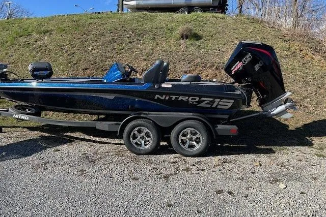The Image of 2026 Nitro Z19 XL Pro boat on trailer, parked outdoors on gravel. - 0
