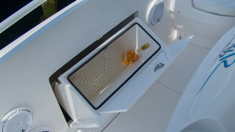 Slide: The Image of Intrepid 400 Cuddy 2017 with open storage compartment and bottle. - 15