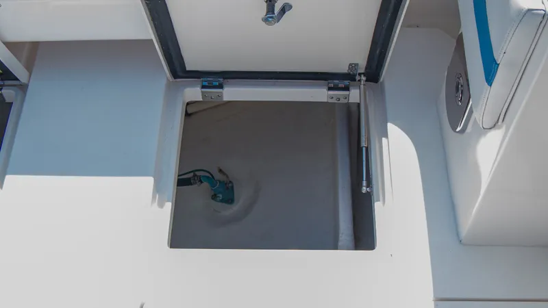 Slide: The Image of Open storage compartment on a 2017 Intrepid 400 Cuddy boat. - 19
