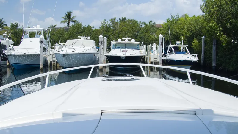 Slide: The Image of Intrepid 400 Cuddy 2017 in a marina with other boats. - 21