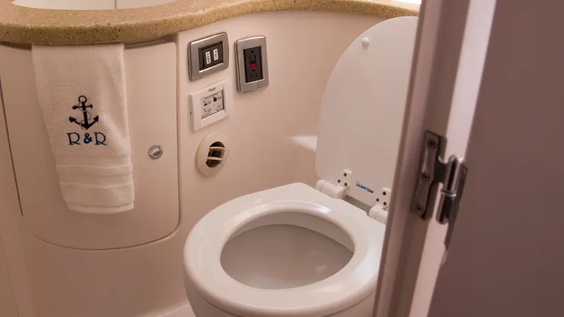 Slide: The Image of Intrepid 400 Cuddy 2017 bathroom with toilet and towel. - 27