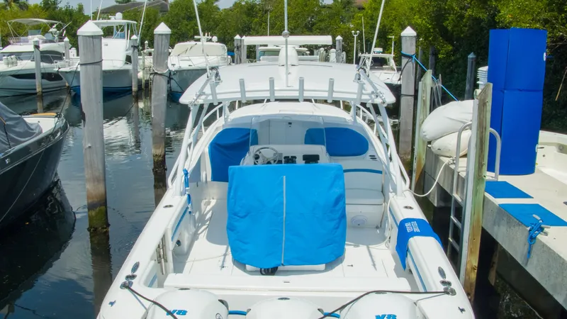 Slide: The Image of 2017 Intrepid 400 Cuddy docked, featuring blue covers. - 32