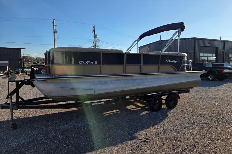 Slide: The Image of 2020 Bentley Pontoons 220 Navigator on trailer in outdoor setting. - 2