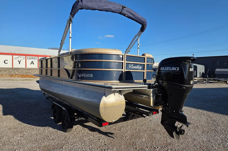 Slide: The Image of 2020 Bentley Pontoons 220 Navigator with Suzuki outboard motor, parked outdoors. - 3