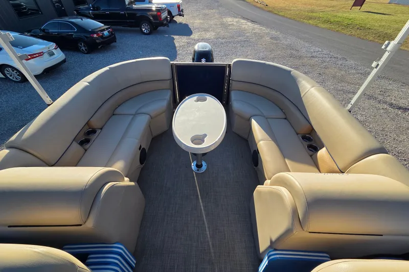 Slide: The Image of 2020 Bentley Pontoons 220 Navigator with beige seating and central table, parked outdoors. - 6