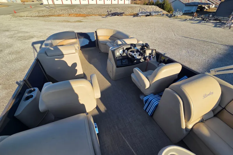 Slide: The Image of 2020 Bentley Pontoons 220 Navigator interior with beige seating and steering console. - 7