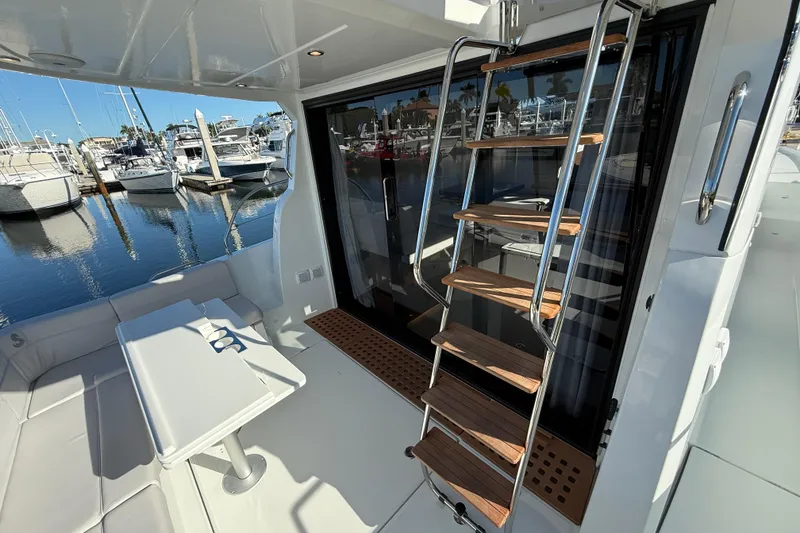 Slide: The Image of 2026 Beneteau Antares 12 yacht interior with ladder and seating area at marina. - 11