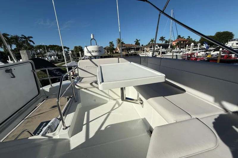 Slide: The Image of 2026 Beneteau Antares 12 yacht deck with seating and table, featuring Garmin equipment. - 13
